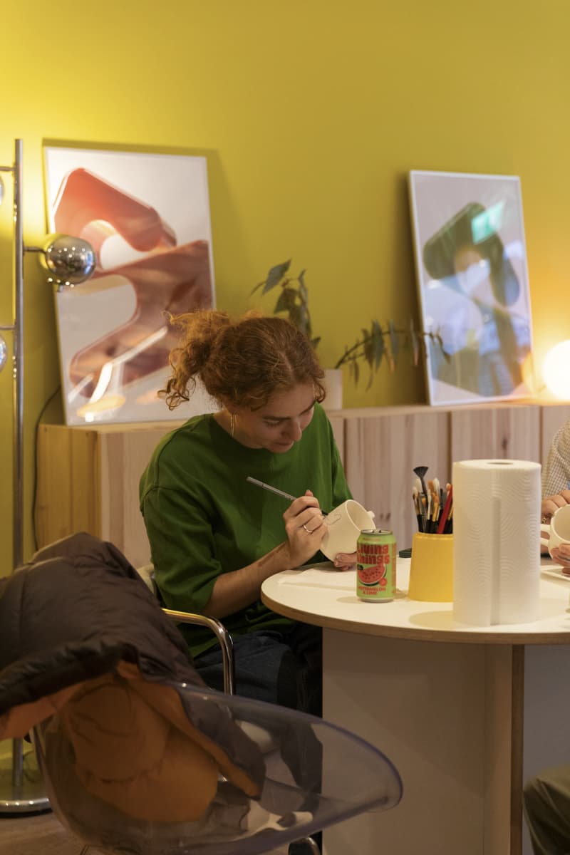 A Female painting a mug